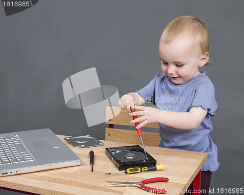 Image of child working at open hard drive