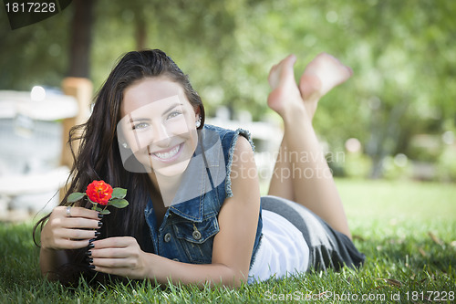 Image of Attractive Mixed Race Girl Portrait Laying in Grass