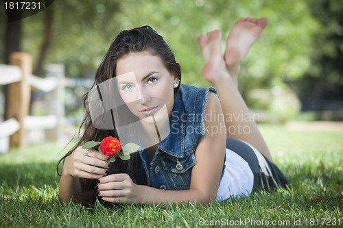 Image of Attractive Mixed Race Girl Portrait Laying in Grass