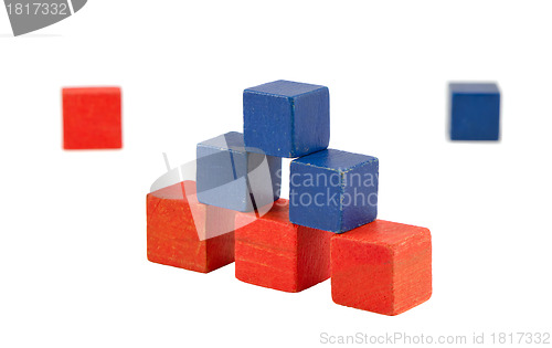 Image of Pyramid made of wooden red blue color toy bricks 