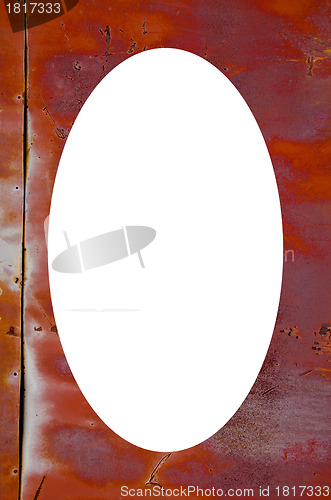 Image of Rusty tin wall and white oval in center 