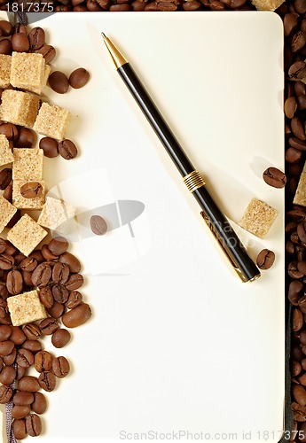 Image of Coffee beans, paper, pen