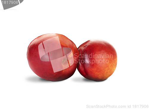 Image of two nectarines with green leaves over white background