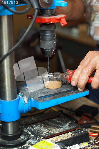 Image of Man working on drilling machine