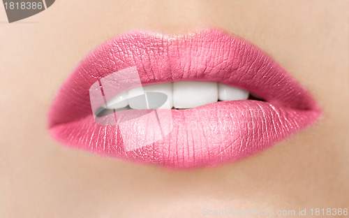 Image of close-up portrait of young beautiful woman's lips zone make up