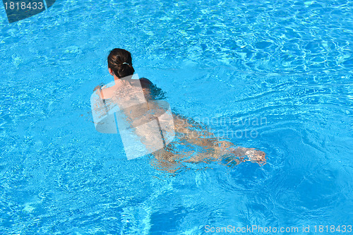 Image of Young woman swiming in the blue sea