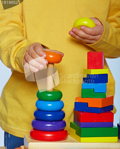 Image of boy playing with pyramid