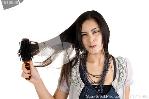 Image of woman brushing her hair