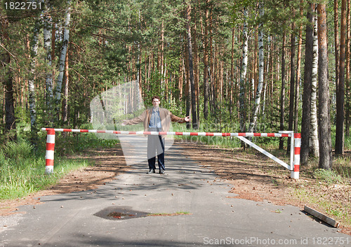 Image of Young man behind a barrier