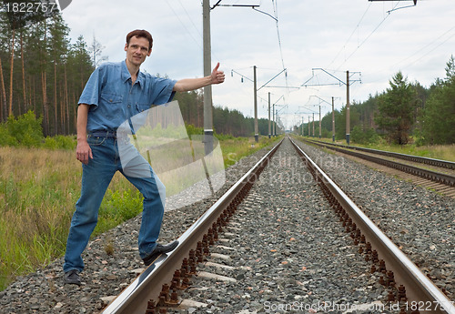 Image of Man on railway with the lifted hand