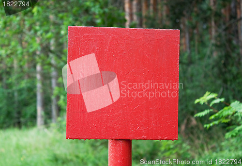 Image of Red metal plate in wood
