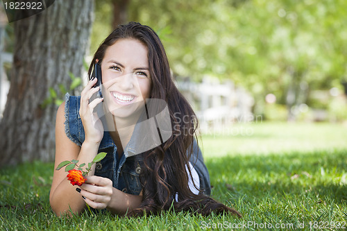 Image of Mixed Race Young Female Talking on Cell Phone Outside