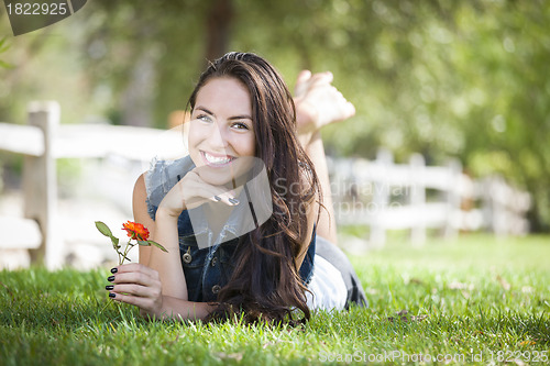 Image of Attractive Mixed Race Girl Portrait Laying in Grass