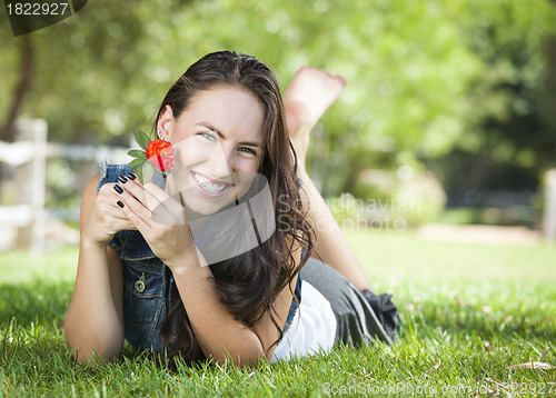 Image of Attractive Mixed Race Girl Portrait Laying in Grass