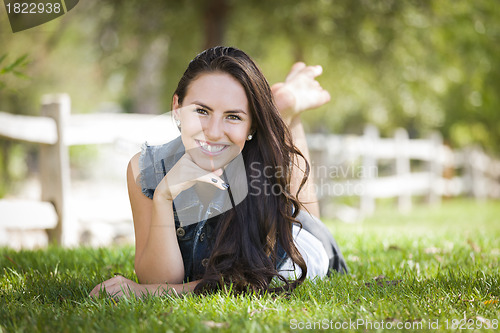 Image of Attractive Mixed Race Girl Portrait Laying in Grass