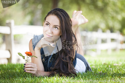 Image of Attractive Mixed Race Girl Portrait Laying in Grass