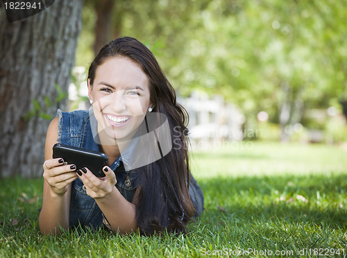 Image of Mixed Race Young Female Texting on Cell Phone Outside