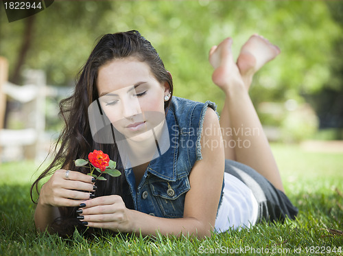 Image of Attractive Mixed Race Girl Portrait Laying in Grass
