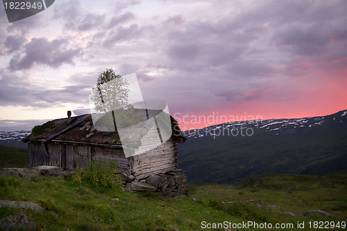 Image of Old abandoned hut with sunset view