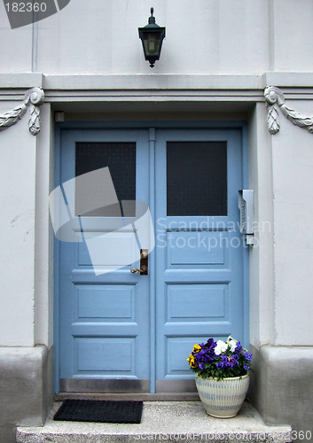 Image of Beautiful blue door and flowers