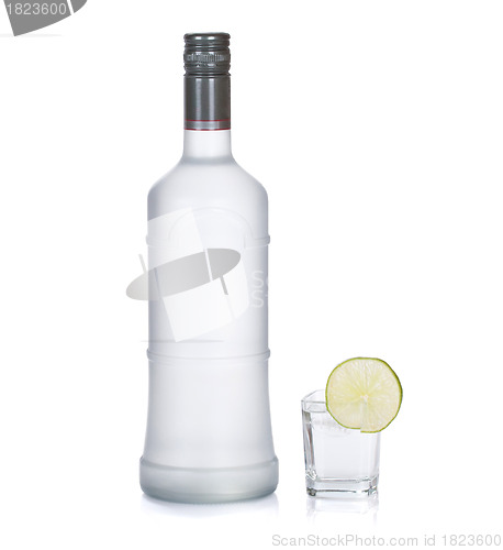 Image of bottle of vodka with lime isolated on white