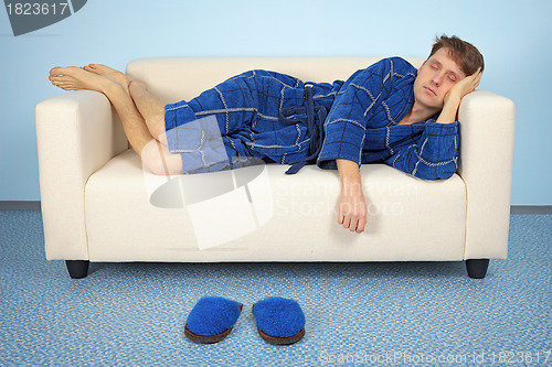 Image of Man is resting at home after work