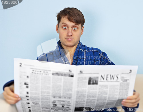 Image of Man reads a newspaper with a admiration