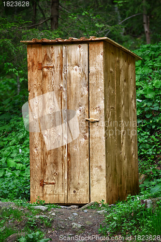 Image of Rustic wooden toilet in the forest