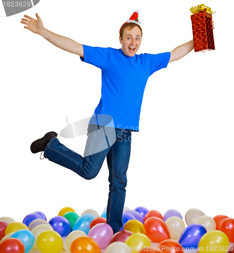 Image of Dancing happy man with a christmas gift