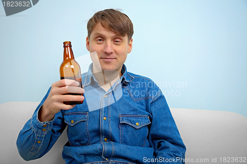 Image of Man relaxing with a bottle of beer