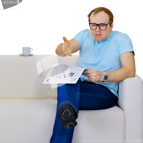 Image of Funny man dissatisfied with news from the newspaper