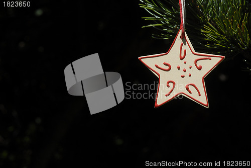Image of christmas, star hanging from the fir tree