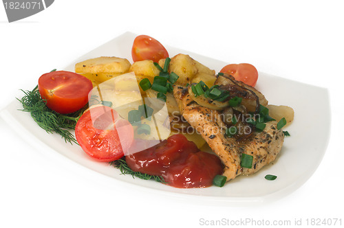 Image of Chicken breast with roasted potatoes and fresh tomatoes.
