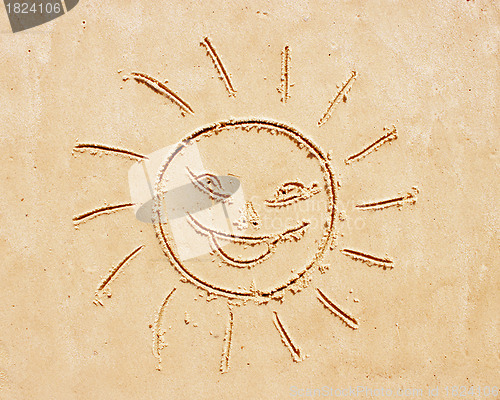 Image of Smiling sun. Drawing on sand