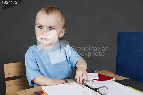 Image of young child at small desk