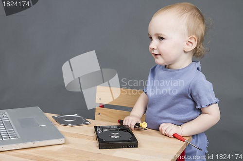 Image of child working at open hard drive