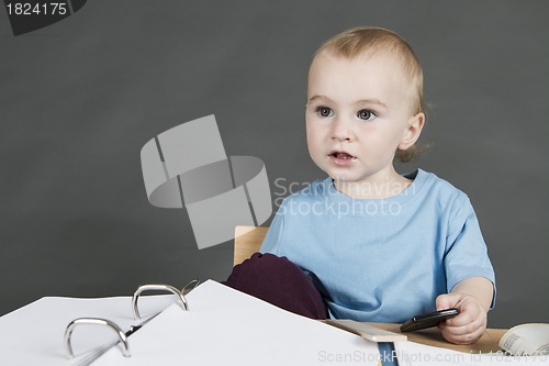Image of young child at small desk