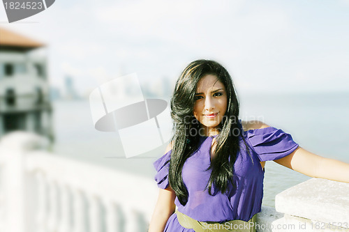 Image of Beautiful lady posing in the beginning of the coast