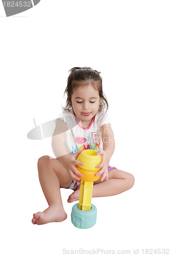 Image of Funny little kid playing with toys, isolated over white 