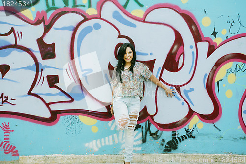 Image of Girl against grafitti wall