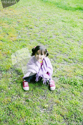 Image of Little girl sitting in the grass - Family life