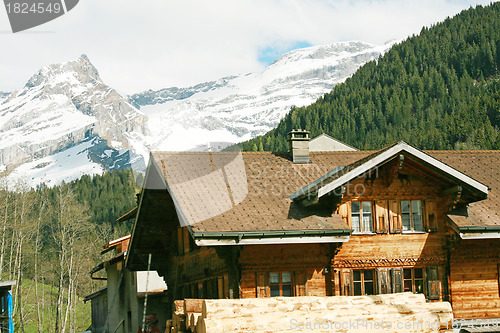 Image of Lovely Swiss chalet with mountains in background 