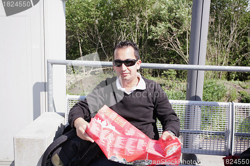 Image of A shot of a handsome caucasian traveling man reading a map