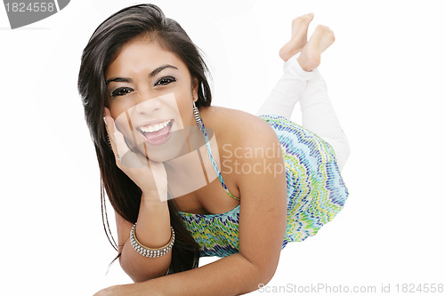 Image of smiling young woman lying on the floor isolated on white backgro