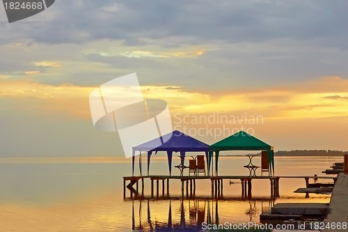 Image of Tents above sea water at sunset