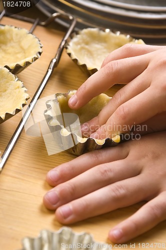 Image of Detail of child hands making cookies