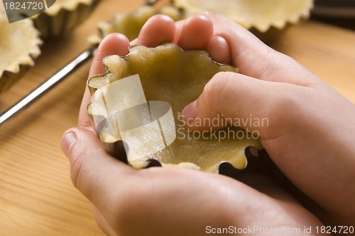 Image of Detail of child hands making cookies