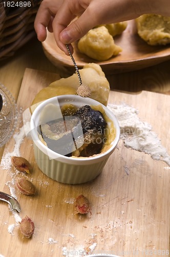 Image of Detail of child hands making plum tart