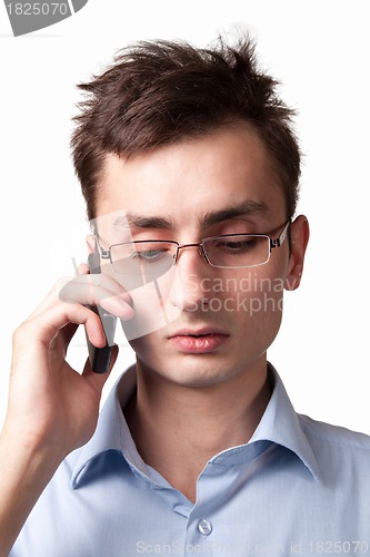 Image of Young businessman talking on the mobile phone