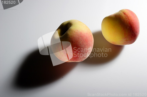 Image of Two peaches and their shadows
